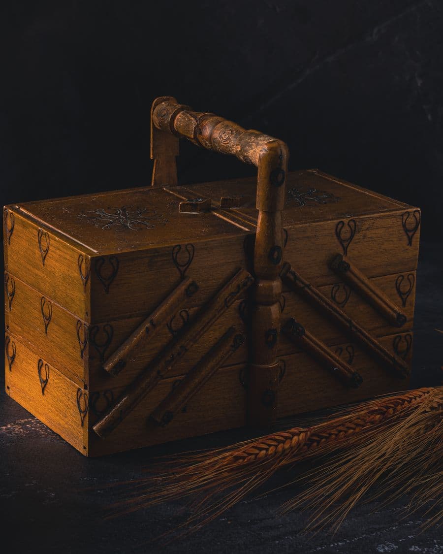 Carved wooden keepsake box lit against a dark background