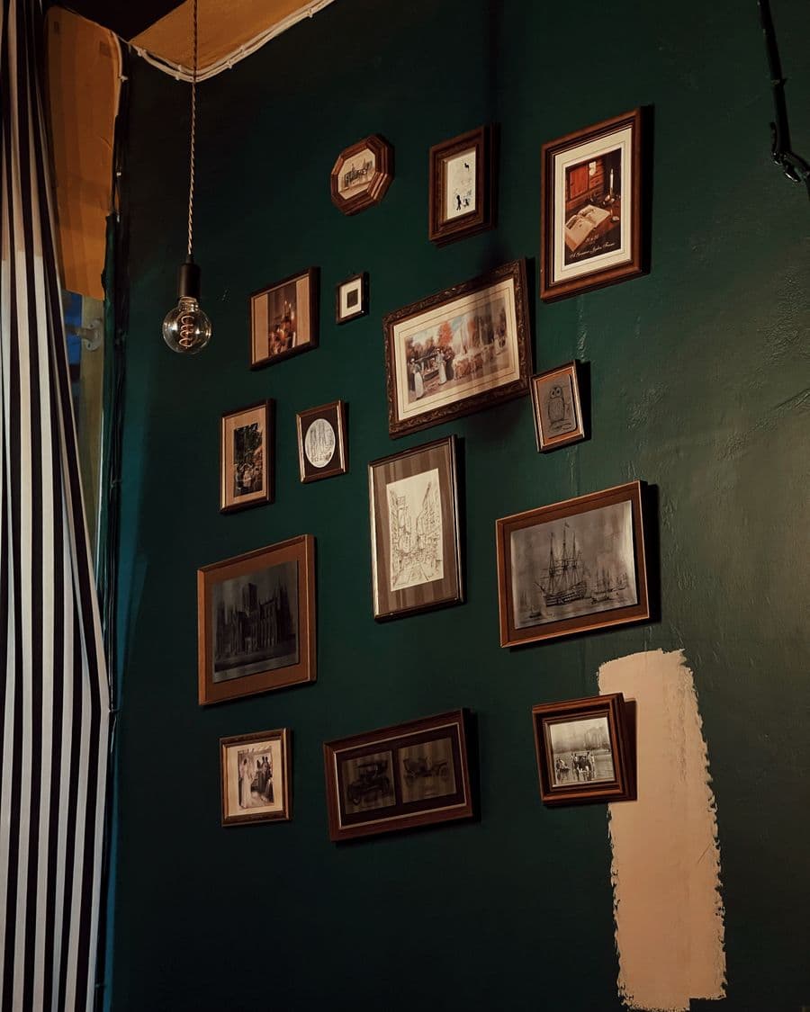 Cluster of picture frames arranged on a dark wall