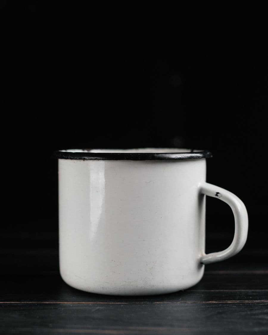 Enamel mug photographed against a black background