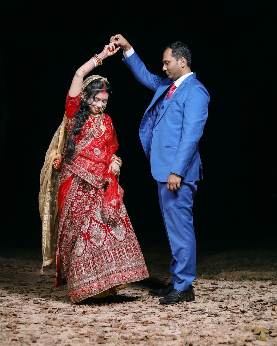 Couple dancing at a night-time Indian wedding celebration